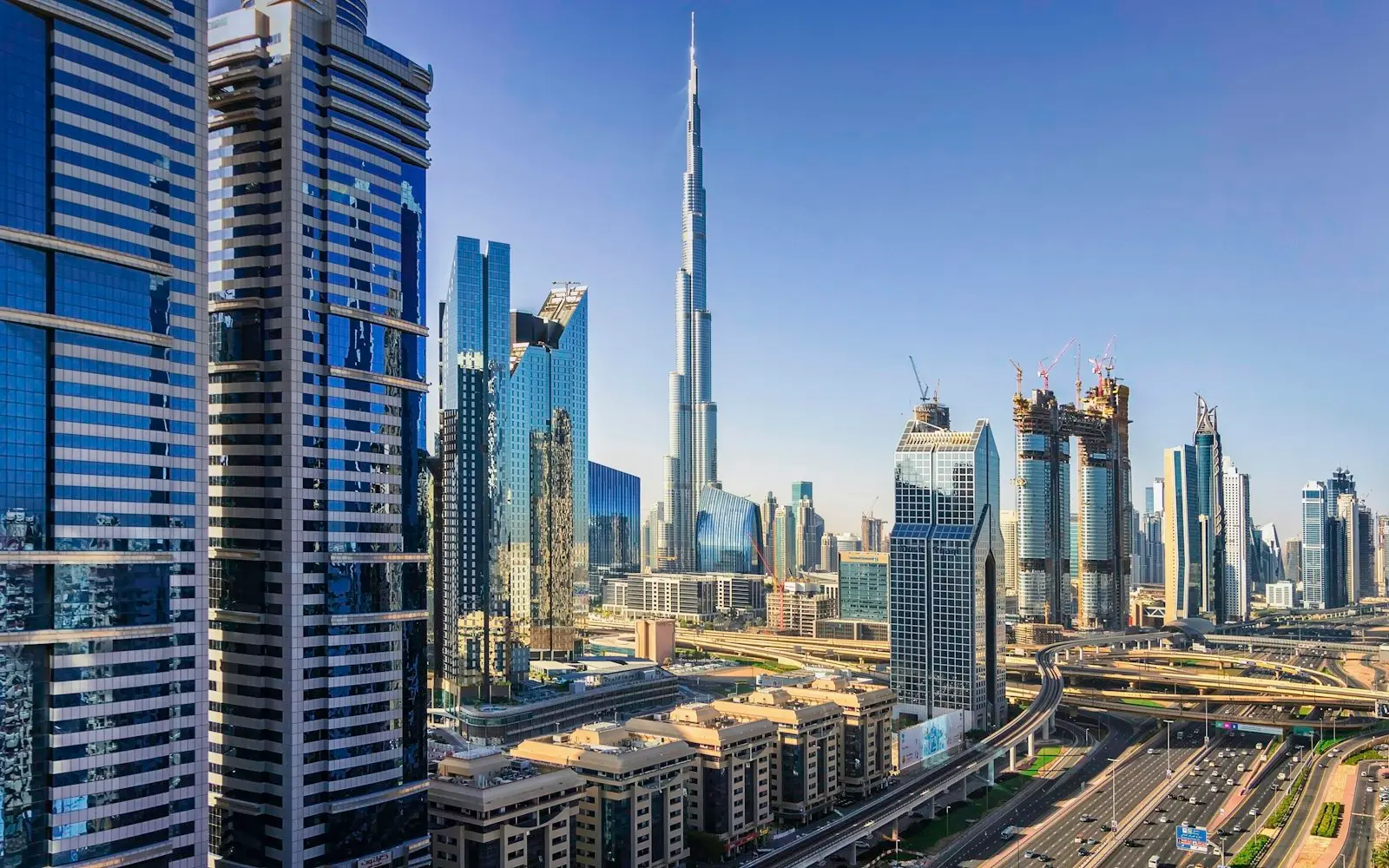 Burj Khalifa and Dubai high-rises under a clear blue sky